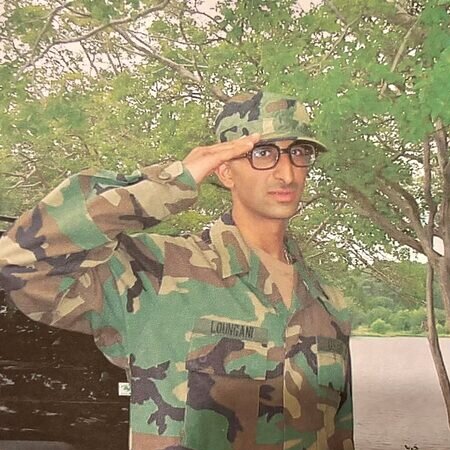 Dr. Raj Loungani saluting in U.S. Army uniform