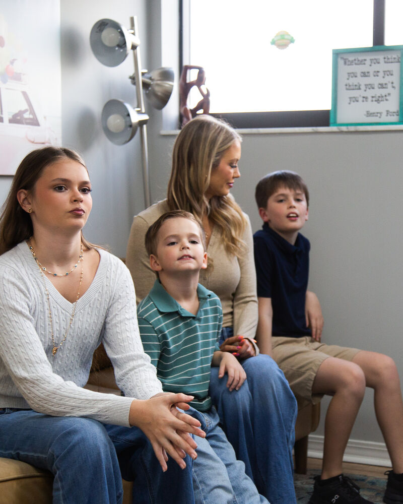 A mother and her children sitting together during a visit