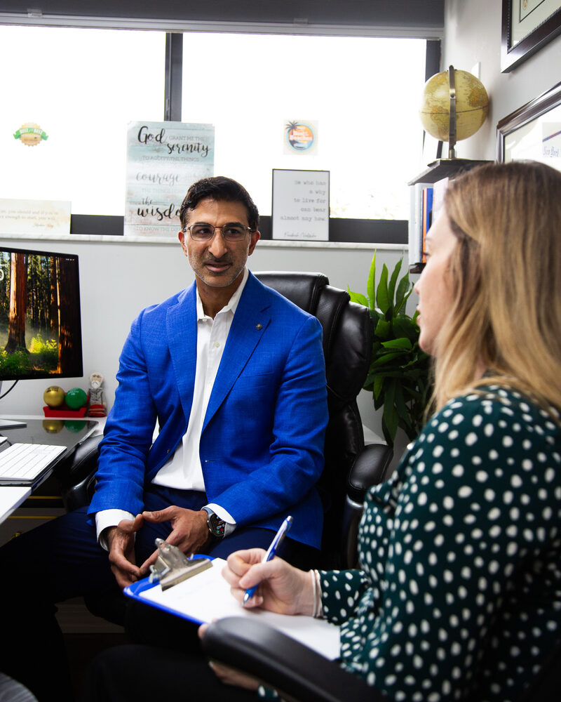 Dr. Loungani talking through a case with a nurse practitioner in his office