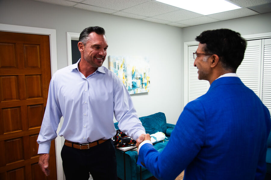 Dr. Loungani greeting a visitor at the office