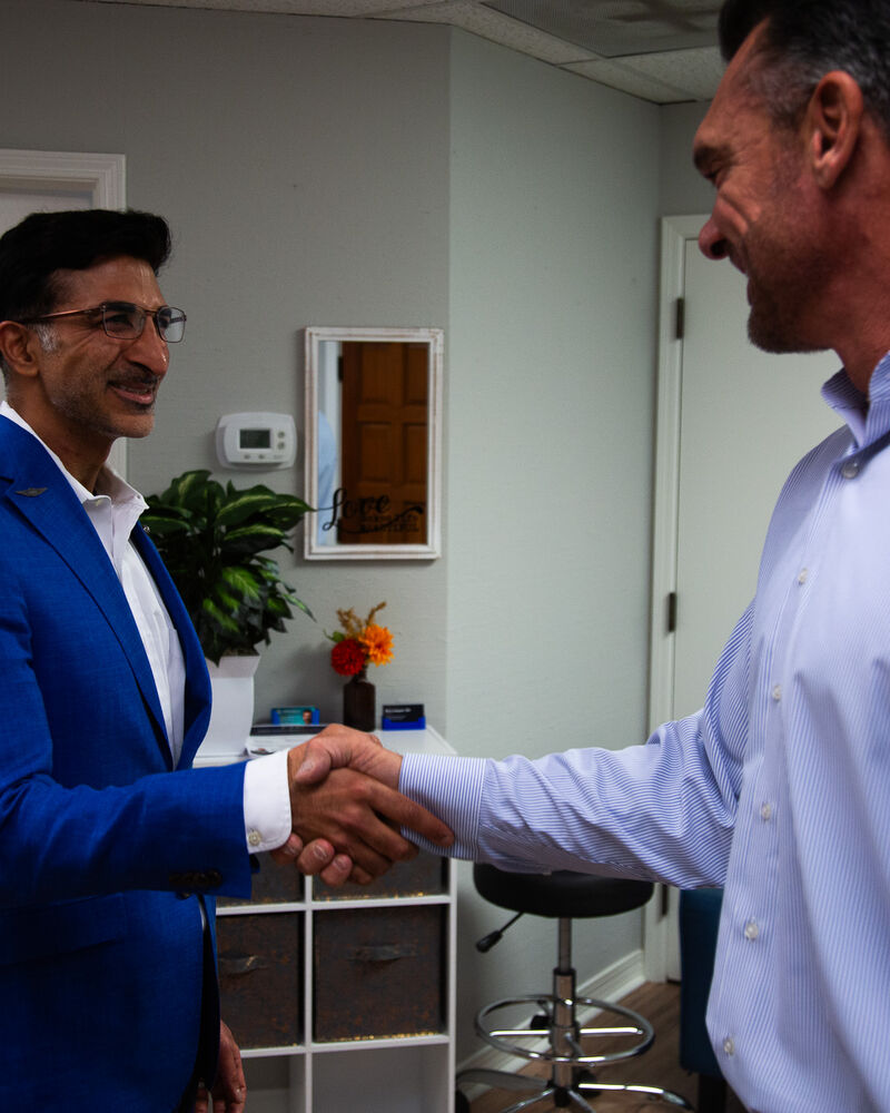 Dr. Loungani greeting a visitor at the Enhance Psych office